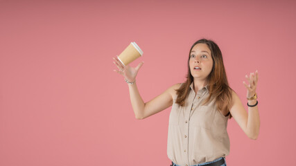 Scared young woman drops coffee cup