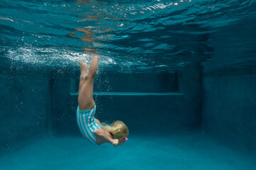 Girl dives to the bottom of the pool