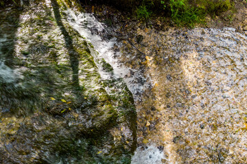 Top view of the stream flow and falling water from small limestone ledges
