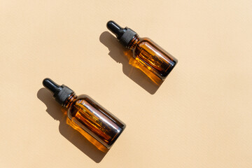Top view of amber glass vials with cosmetic serum. Containers without labeling for cosmetics with...