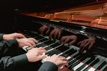4 Hands close-up with a musical instrument
