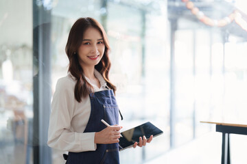 Beautiful female manager in restaurant with tablet. Man coffee shop owner with open sign. Small business concept