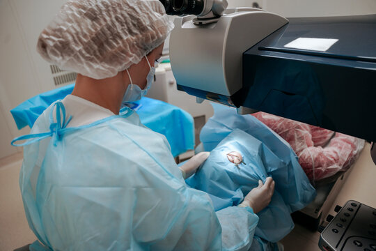 The surgeon performs an eye operation