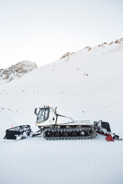 Snowcat on snowy mountain slope