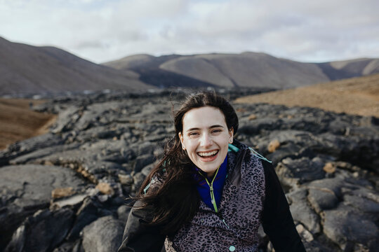 View Of young smiling Women standing on volcano in Iceland