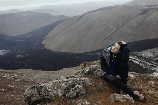 Scenery View Of young Women looking on volcano in Iceland