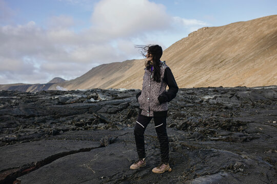 Scenery View Of Yang Women standing on volcano in Iceland
