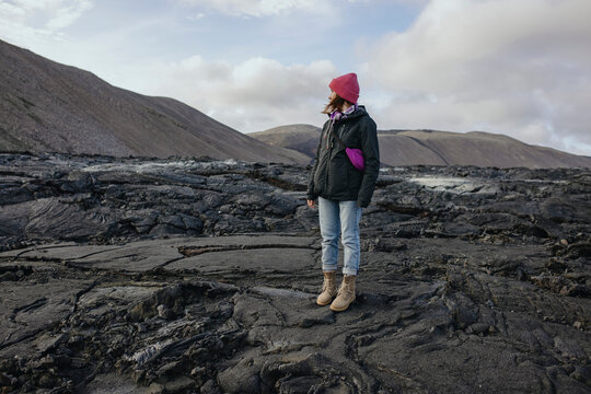 Scenery View Of Women standing on lava in Iceland