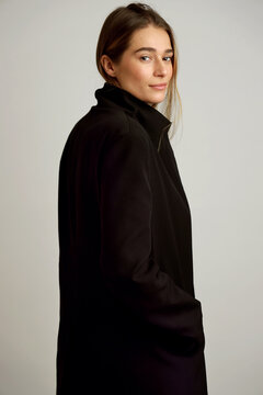 portrait young woman in black coat