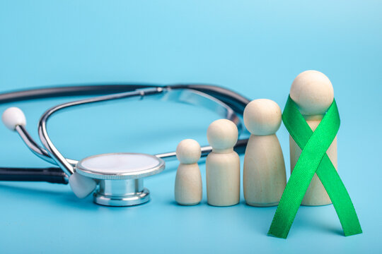 Green ribbon and stethoscope.treatment concept for ovarian cancer and cervical cancer.