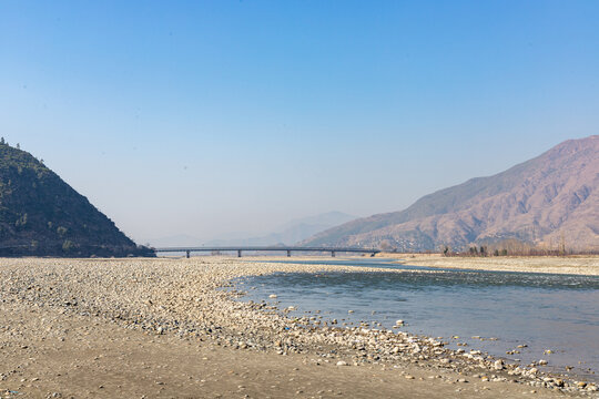 Beautiful scenery of a river and steel bridge in swat valley, Pakistan