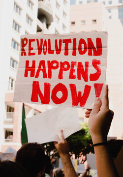 "Revolution Happens Now" Protest Sign
