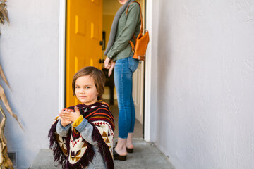 Crop mother and cute son leaving home