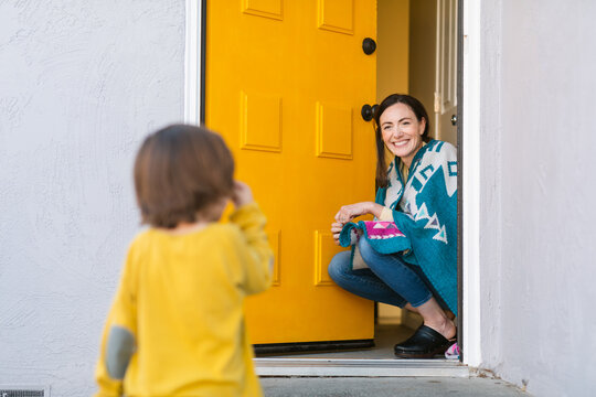 Kid And Happy Mom Front House With Yellow Door