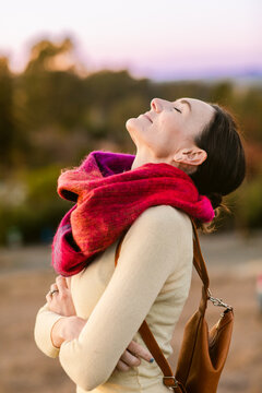 Woman feeling good by the field in autumn