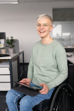 Happy Woman In The Wheelchair At Office 