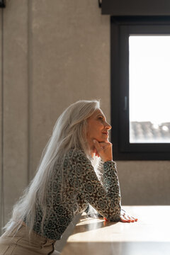 Portrait of mature woman with long white hair
