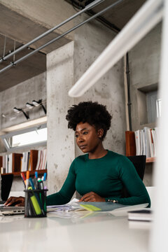 Young Black Woman Working At The Desk In The Office