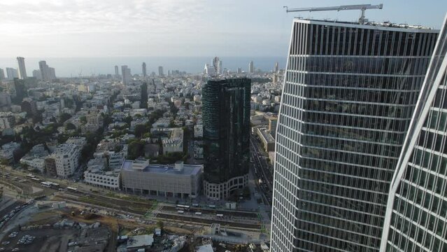Flying from work, drone shot near office towers facing the sea