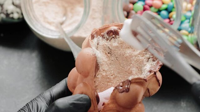 Decorating a waffle with marshmallow. Cooking a tasty bubble waffle dessert.