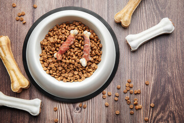 A bowl of dog food on a wooden floor.