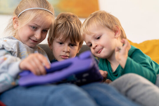 group of kids looking at tablet