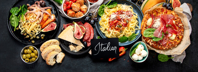 Dinner table of italian meals dishes.