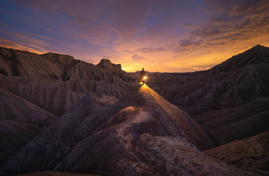 Person exploring the desert at night, Spain.