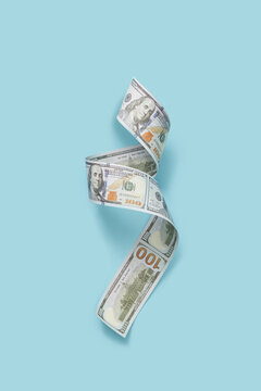 Extended dollar banknote on blue background.