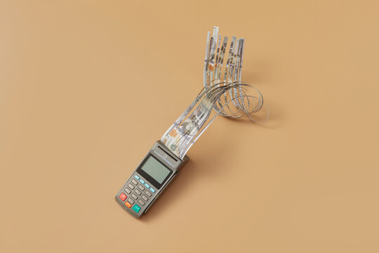 POS terminal, cut printed dollar bill.
