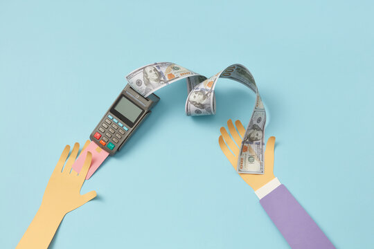 Payment terminal, paper hand with dollar receipt.