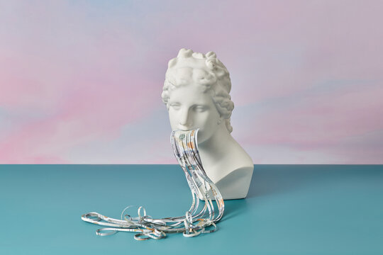 Long cut dollar banknote sticking from sculpture.