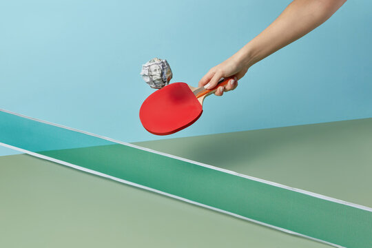 Dollar ping-pong ball with racket in female hand.