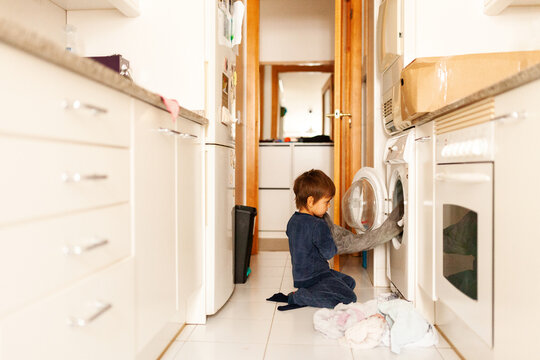 kid doing laundry