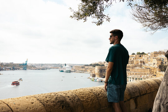Man looking at the views of Malta from the Lower Barrakka Gardens