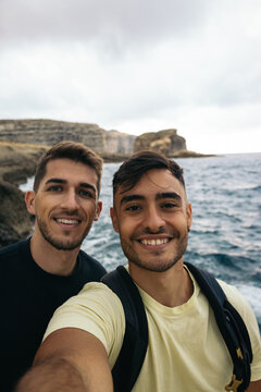 Selfie of two friends on the cliffs of the Azure Window in Malta
