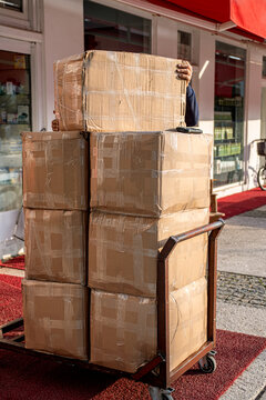 packed boxes with goods on trolley