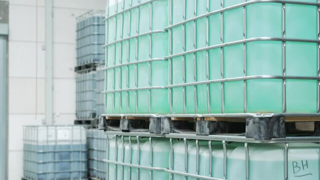 Caged IBC Tote filled with liquid inside warehouse