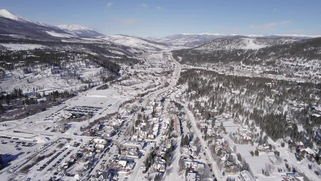 Aerial Footage of snowy Silverthorne, Colorado during Winter. Town and Forest.  Daytime. Pushing in.