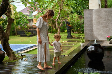 Mom And Child Play Together In Nature.
