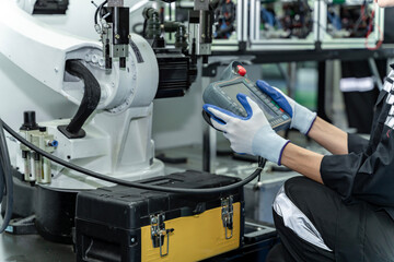 Team woman of engineers practicing maintenance Taking care and practicing maintenance of old machines in the factory so that they can be used continuously.