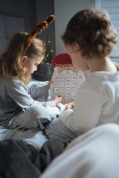Two children with Christmas advent calendar