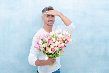 happy man with valentines tulips. man with valentines tulips in studio.