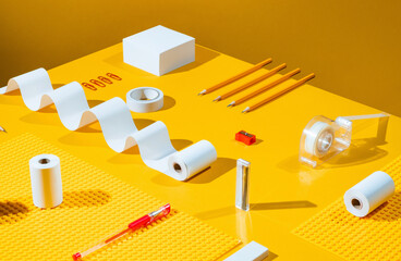 Neatly organised stationery on yellow.