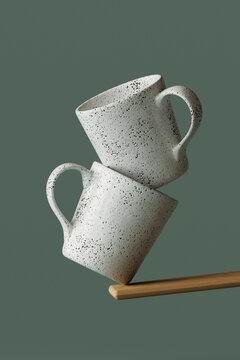 mugs balancing on a wooden stick