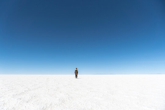 Man walking in the salt flat alone