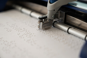 Close-up of a braille code printing machine. 