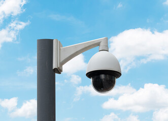 Outdoor white CCTV on pole with blue sky background and copy space