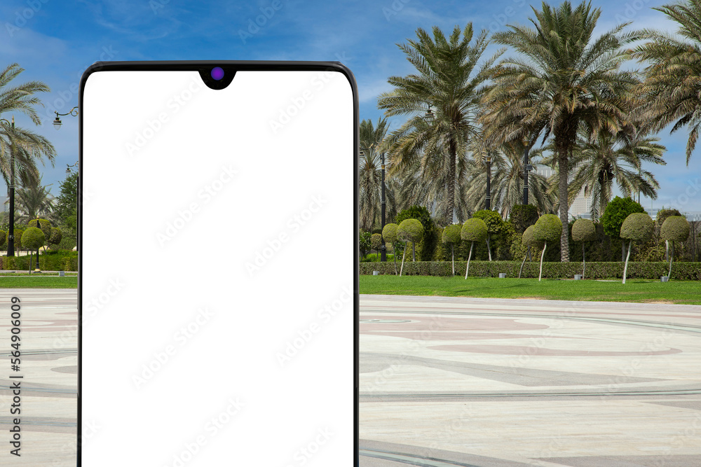 Poster modern mobile phone with blank screen in front of empty city street with palm trees. 3d rendering