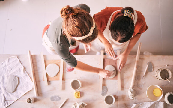 Pottery class, ceramic workshop and team design sculpture mold, clay manufacturing or art product. Diversity, retail store and top view of startup small business owner, artist or studio women molding
